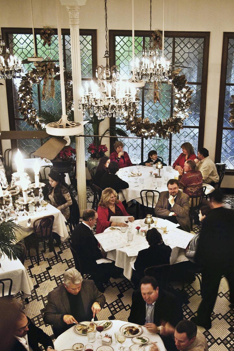 Arnaud's Restaurant showing people sitting at dining tables during Reveillon Dinner.