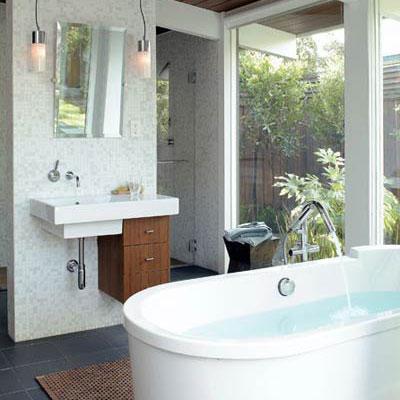 моден style bathroom with a hanging white sink and wooden drawers hung on the lower-right side, below and a stand-alone modern tub in the middle of the room