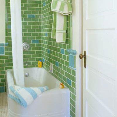 ملون green tiles (interspersed with light blue tiles) line the walls of a retro styled bathroom