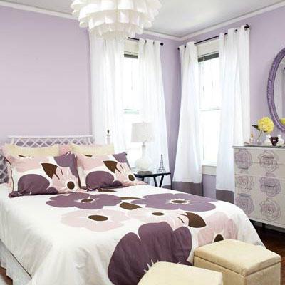 イン the master bedroom, purple flowered bedspread with pale purple walls, white curtains and a white, modern chandelier