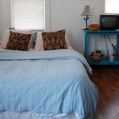 前に photo of a bedroom with a pale blue duvet cover