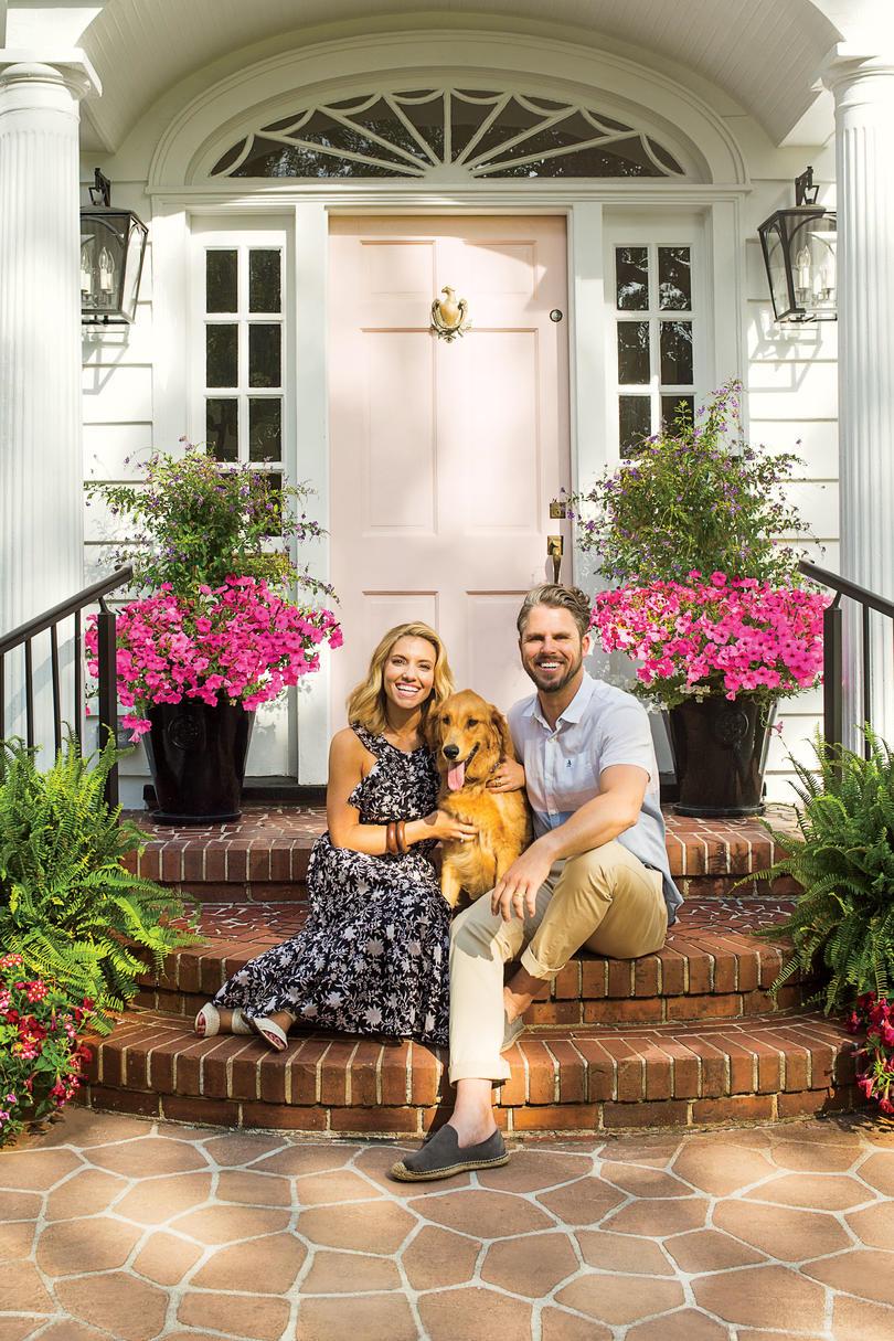 Линдзи and Grayson Cheek in front of their Wilmington, NC Home with a Pink Front Door
