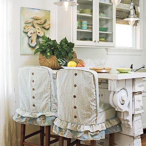 къдри line the bottom of the casual, cottage-style slipcovers with brown buttons running vertically down the back of each slipcover