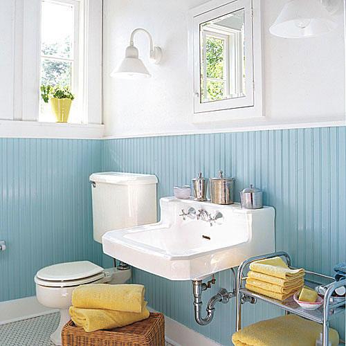 червеношийка egg blue beaded board lines the bottom half of the remodeled bathroom with white walls above as well as a new white sink, white medicine cabinet and a toilet to the left