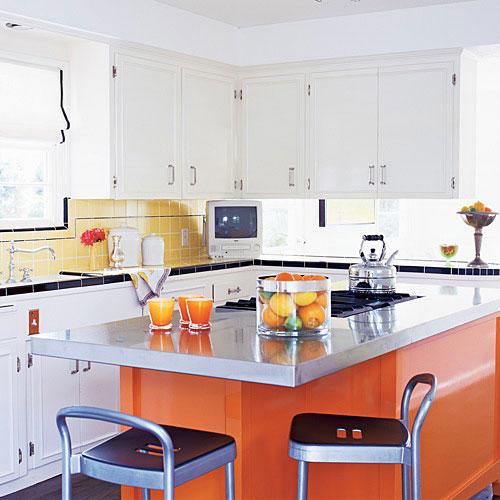 ا bright, orange, modern kitchen island with a steel countertop sits in the middle of this updated, vintage style kitchen
