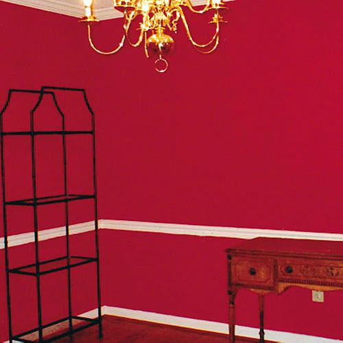 前に photo of a red painted dining room with spare furnishings 