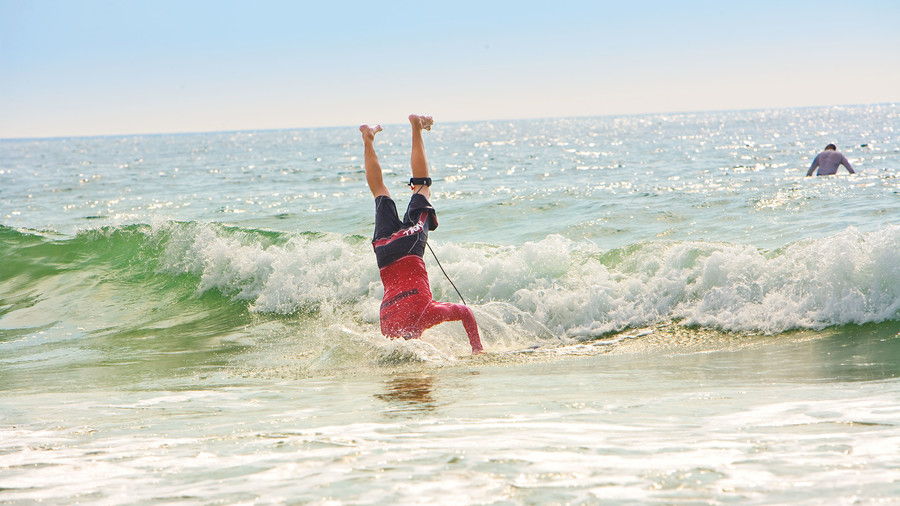 marca McCann performs Headstand at WB Surf Camp
