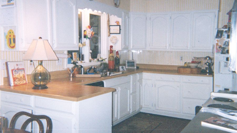 بتاريخ kitchen with white cabinets, wooden countertops in a u-shape with a window over the sink