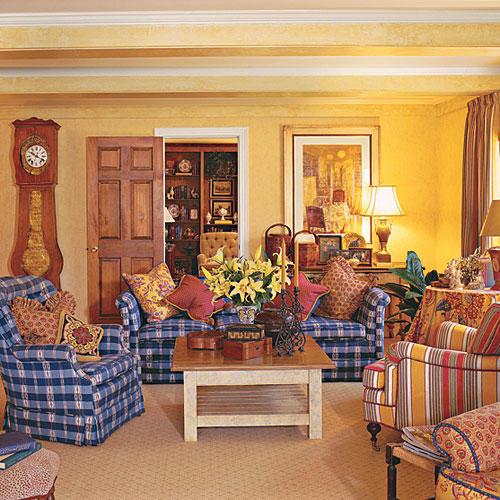 ярък yellow walls liven up and compliment blue and white checkered couches and chairs in the living room 