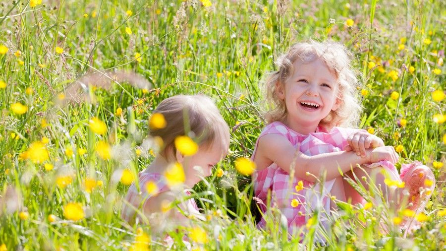 Batole girls playing in flower field