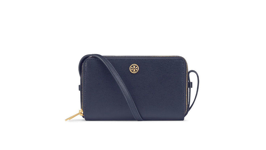 Говоря about wiggle room. Two zippered compartments mean you can pack a lot into this bitty cross-body. Plus, the classic navy hue will carry you far beyond football season. (It also comes in camel and hot-hot pink.)