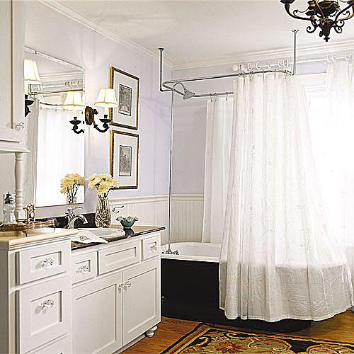 هوائي white bathroom remodel with a black, clawfoot tub with a white shower curtain and a built-in custom sink cabinet with clear drawer knobs